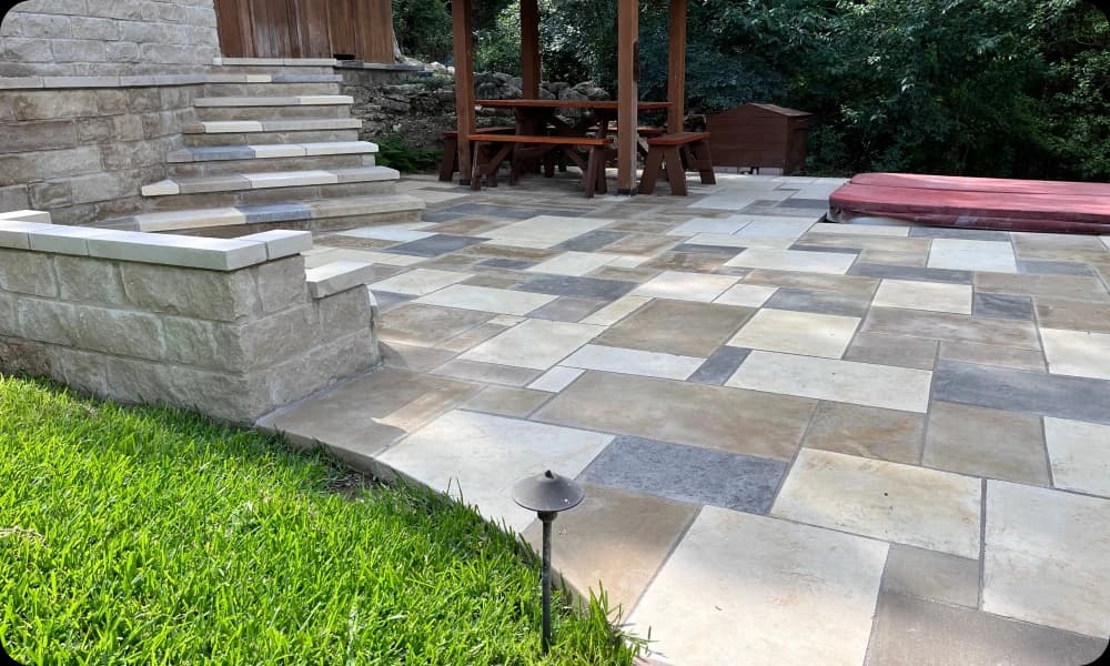 Stone and Tile Tri Colored Patio as part of a lush garden
